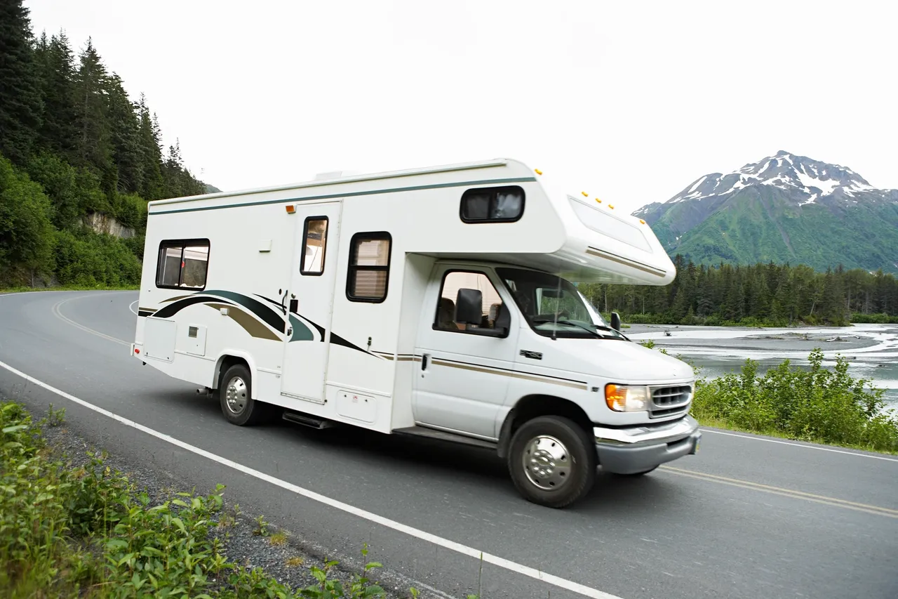 Campervan traveling through lush landscape